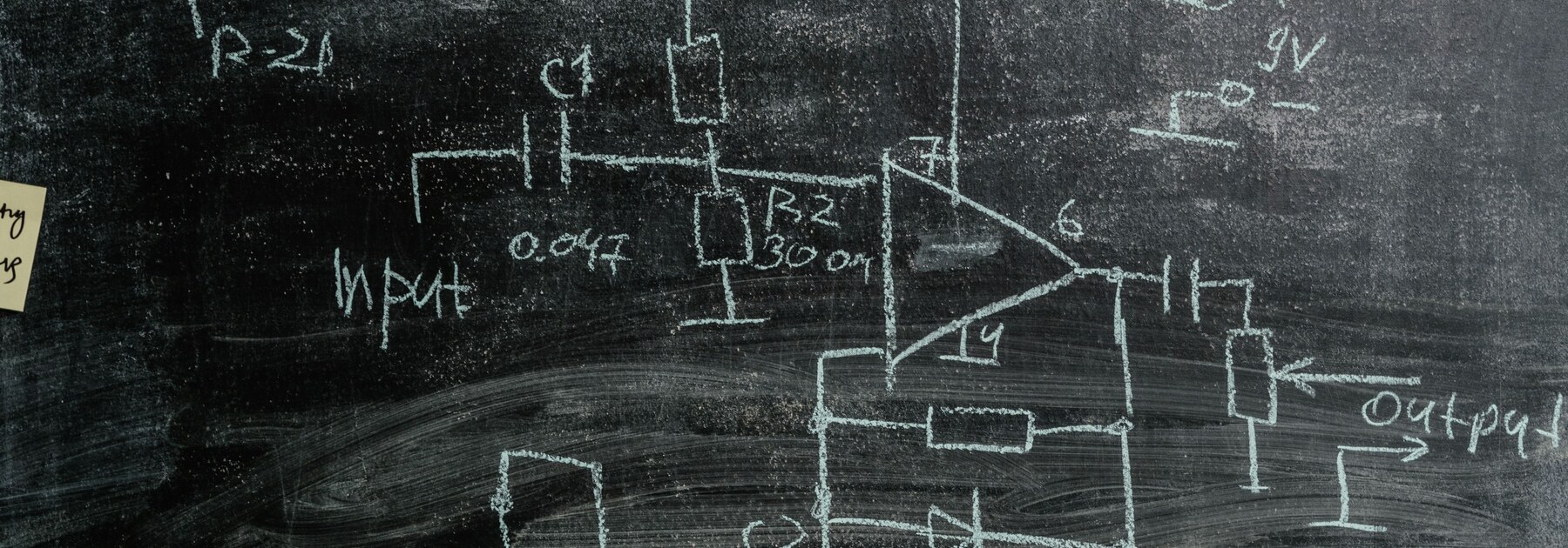 A research chalkboard covered with revised, erased, and overlapping formulas and diagrams.