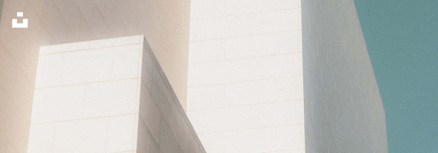 Minimal architectural forms separated by a large field of open sky.